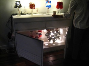 Carolyn Lau's kitchen cabinet installation with Hangovers 1-7 on cabinet counter and Tin Kosong inside 